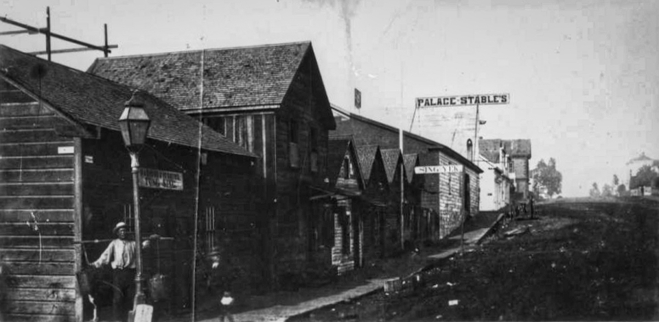Buildings along street with man standing