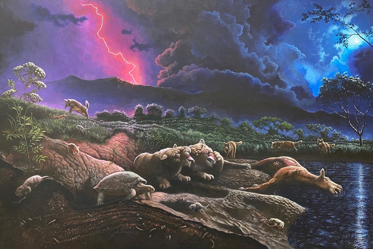 Two sabertoothed cats groom each other at night. The moon and lighting light up a rainy night sky. In the background are a horse carcass, coyote, rabbit, dire wolves, desert tortoise, toad, and small rodents.