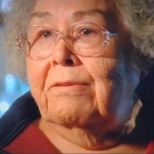 An Alaska Native Woman with glasses and curly gray hair