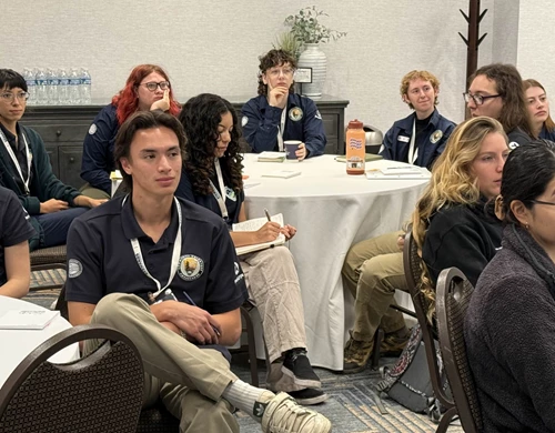 Attentive Community Volunteer Ambassadors engage in a training session. 