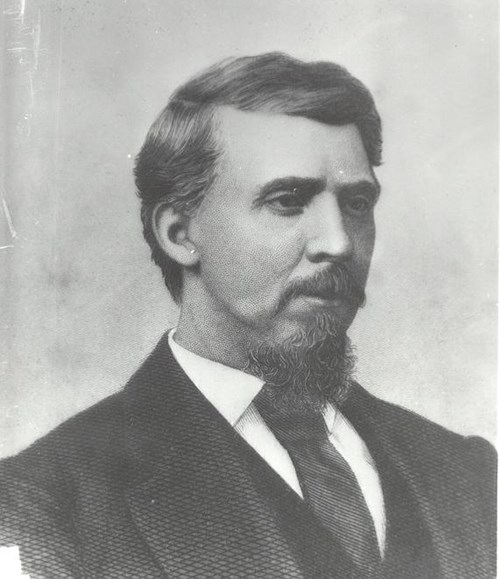 Judge Isaac C. Parker in black and white with dark hair and a dark beard wearing a dark suit and tie.