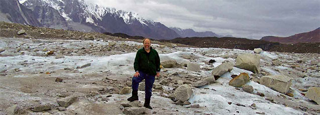 Bob Winfree stands in a field of rubble and ice