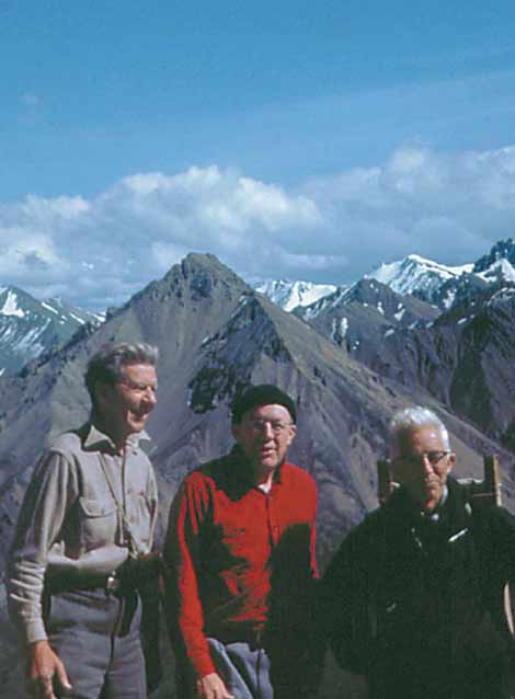 three old men standing on a mountain top