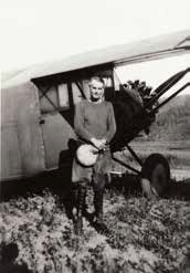 man standing next to a small plane