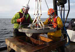 two men using equipment on a boat