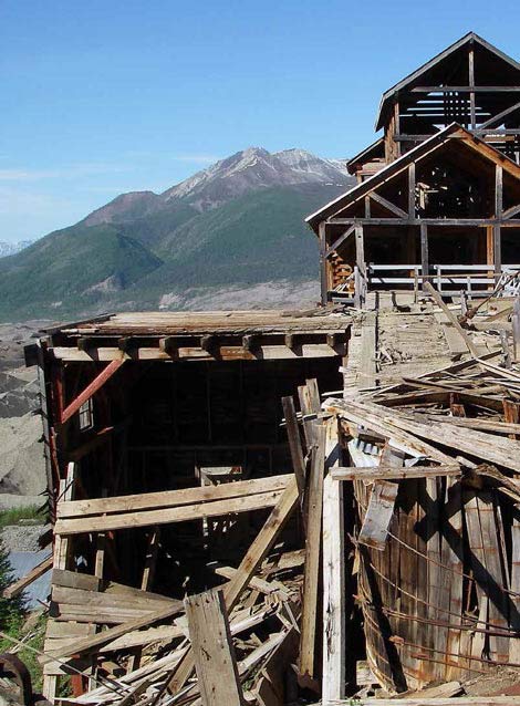multi-story dilapidated wood building in a mountain setting