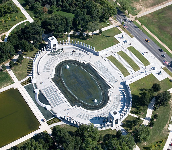 Ariel image of an oval memorial with fountains in the middle and two towers on the short ends. 