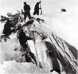 black and white photo of airplane wreckage in snow