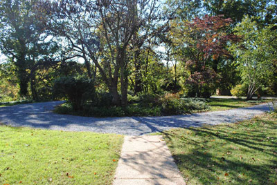 The round driveway at the Clara Barton House surrounds an island of trees and shrubs.