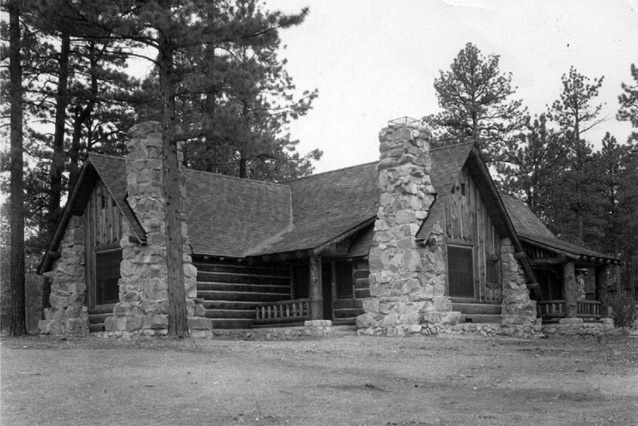 Stacked stone pillars at the corners of the log lodge contribute to its rustic appearance. 