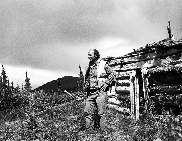 A CPSU anthropologist in front of a cabin.