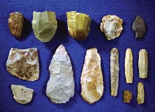 stone tool artifacts displayed on a blue background