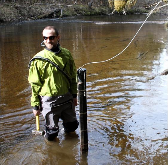 man stands in a river