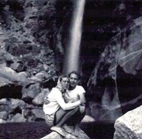 Couple stands in front of Yosemite falls in the 1950s.