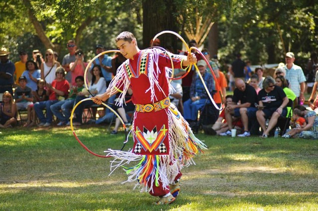 Native American hoop dancer performing for a crowd