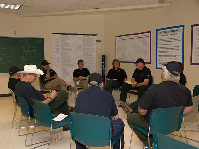 Incident management team members seated in a circle for a meeting