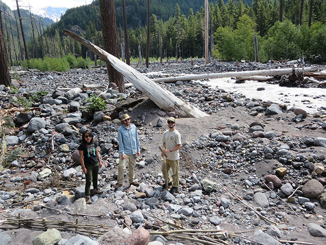 Interns standing in rocky river bed