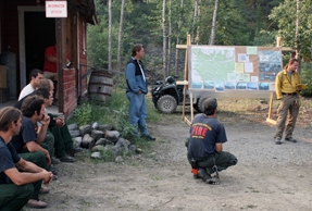 The incident commander speaks at a fire briefing 