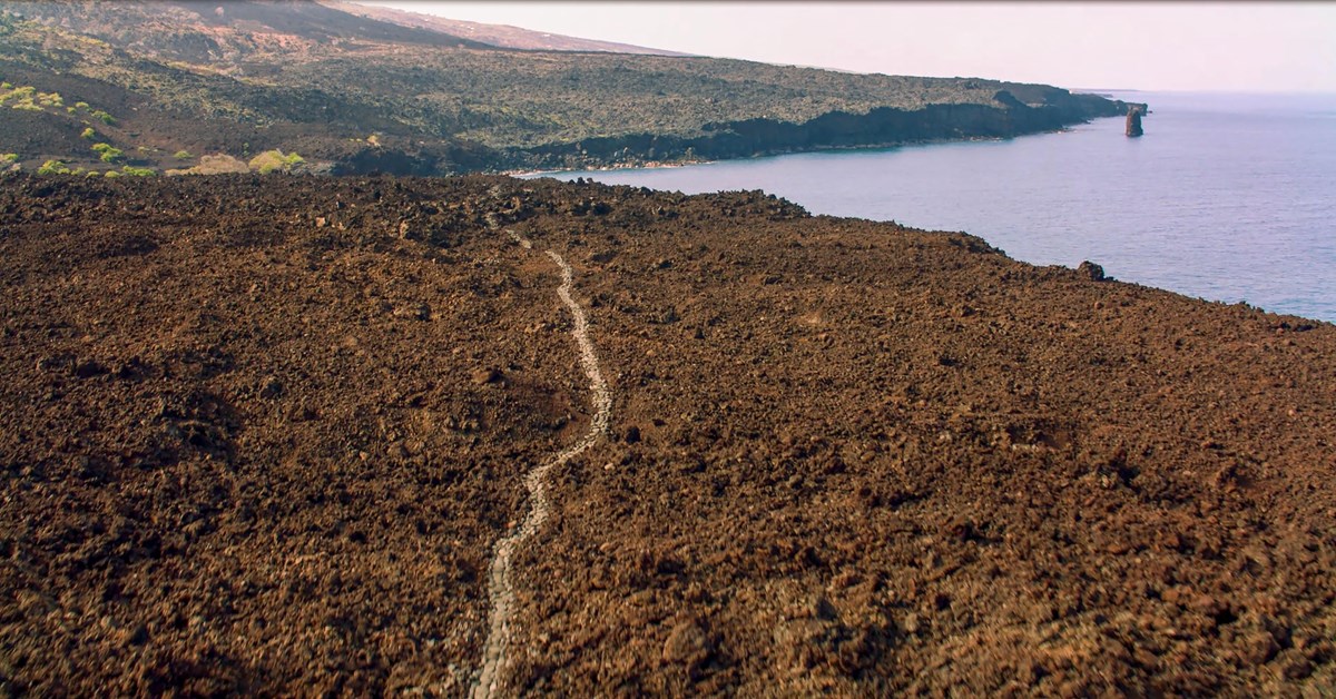 Aerial photograph of trail through lava along the Hawaiian Coast