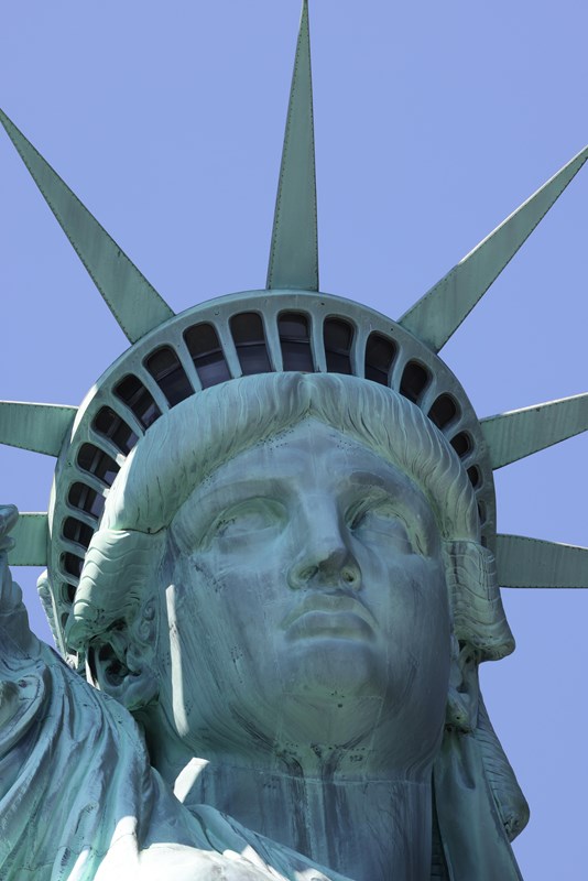 A close-up of the Statue of Liberty's face and crown.