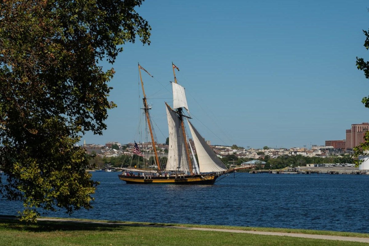 A tall ship sails on the water.