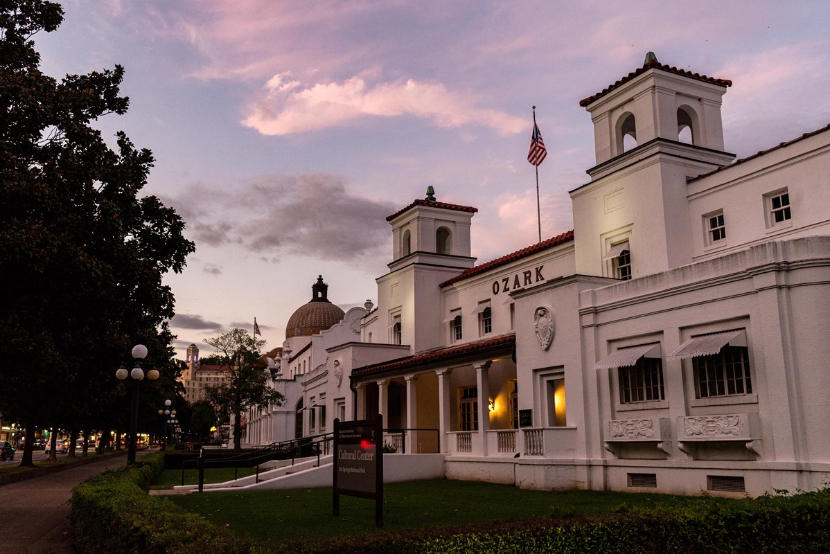 A pink sky above gentle white buildings 