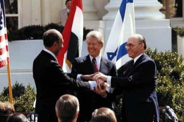 Egyptian President Anwar Sadat, left, U.S. President Jimmy Carter, center, and Israeli Prime Minister Menachem Begin clasp hands at the White House 