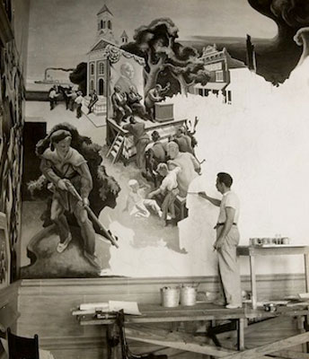 Black and white photo of a man painting a large mural.