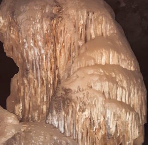 formation with dripping limestone in dark cave