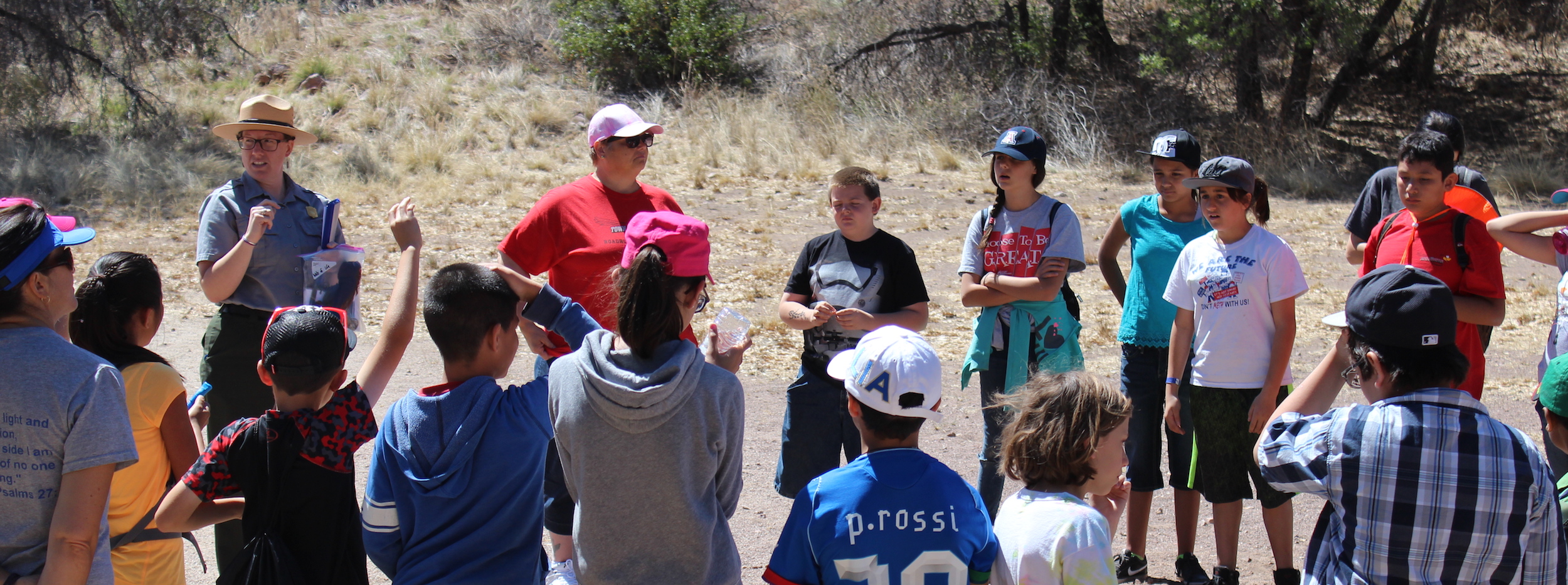 Kids in a circle outside with ranger