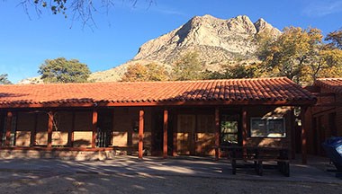 Visitor center building with mountain peak in the background