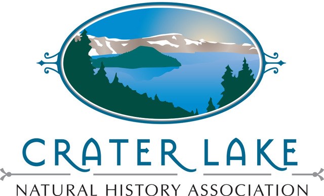 Crater Lake NHA Logo shows an artistic rendering of Crater Lake with Wizard Island, trees, and caldera