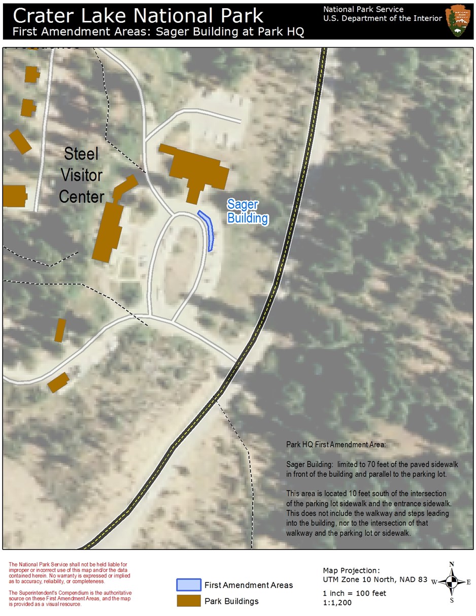 Map of park headquarters area. Munson Valley Road is black with broken yellow stripe. Secondary roads are white. Eight buildings are brown. An area in blue near Sager Building shows the First Amendment area. Related text in lower right corner.