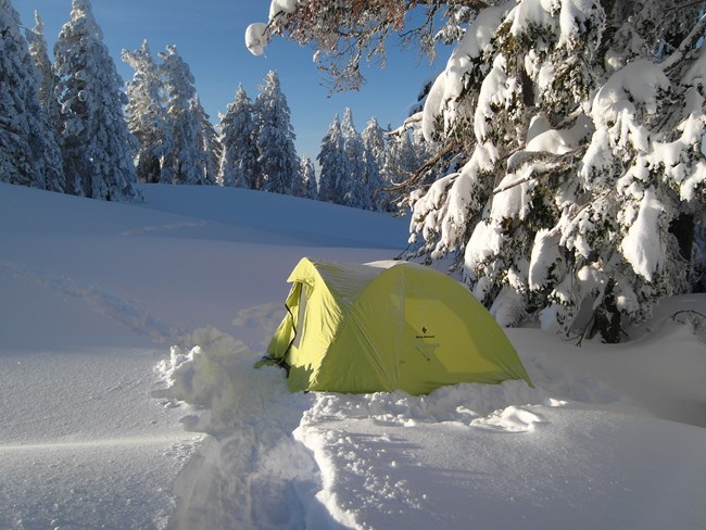 Tent set up on top of deep snow