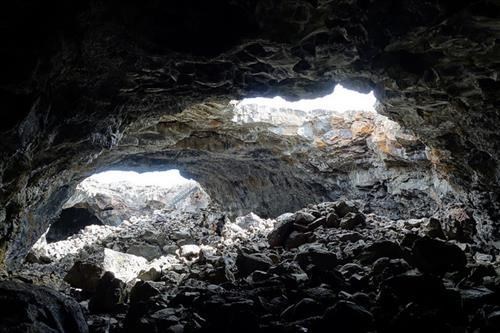 two skylights in the ceiling of a large cave room