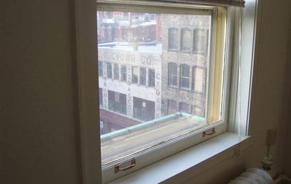 Close-up of an interior storm window and a window, showing that they match.