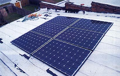 Solar panels on the rear slope of a rowhouse.