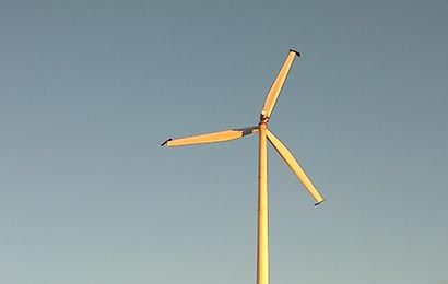 Wind turbine in a parking lot.