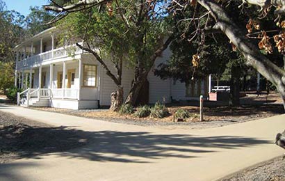 Walkways constructed of an environmentally-friendly aggregate material leading to a historic house.