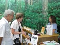 Volunteer welcomes visitors at park visitor center