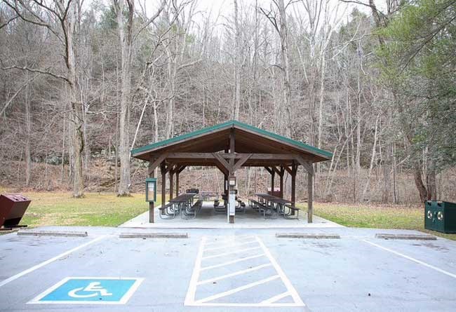 Front of New Bartlett Park Picnic Shelter showing parking, recycle bins and trash receptacles.