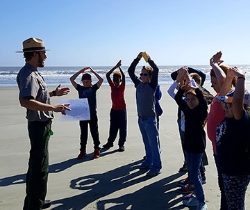 A ranger leads a program on the beach