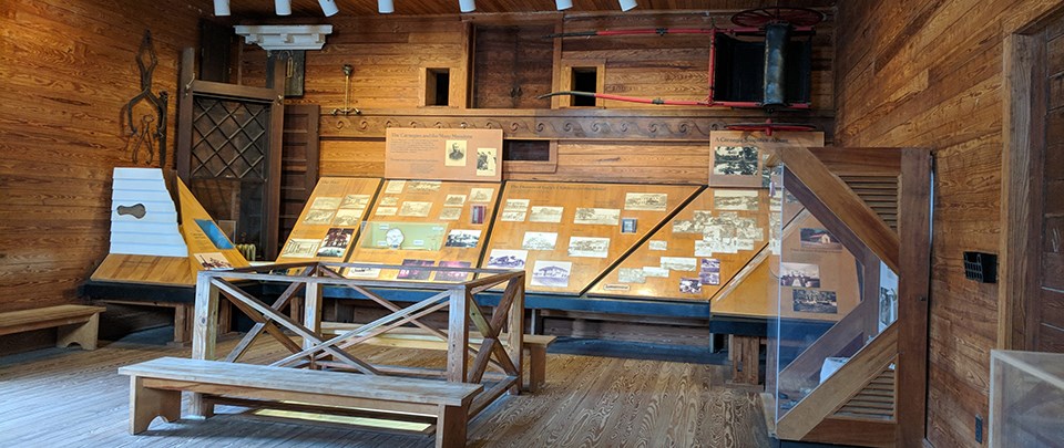 Exhibit display with horse cart, building materials, and ice moving equipment