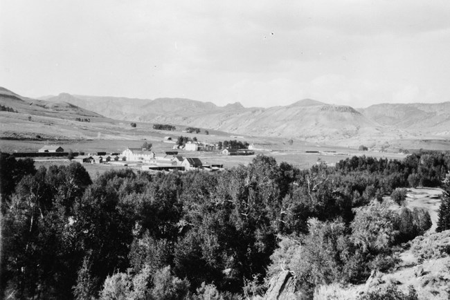 Historic black and white image of View of Sapinero, many buildings, Denver and Rio Grande Western station, and stock pens.