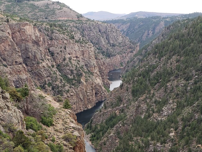 View into a narrow canyon with steep walls and water below