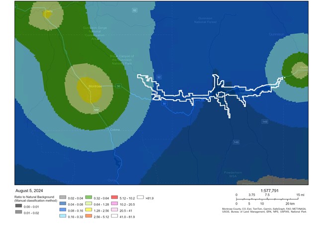 Map showing light pollution using shaded colors. Blue is less pollution, green and yellow are more. Park is outlined in white.