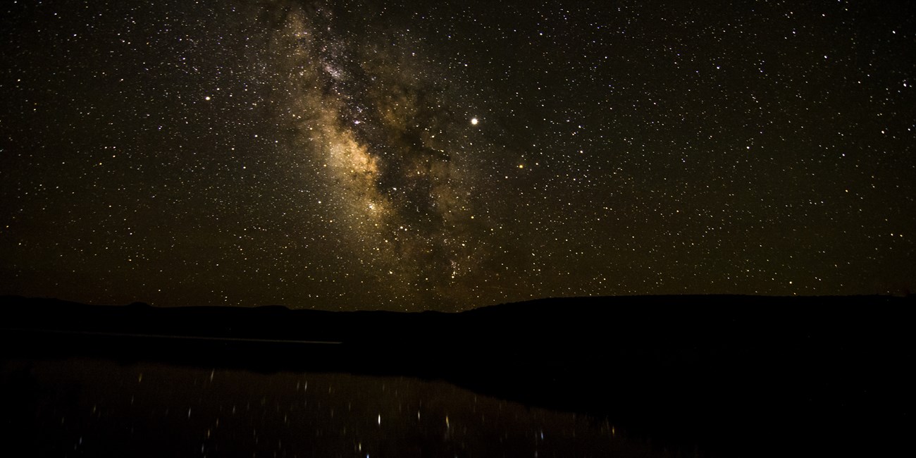 Milky Way and dark skies over a reservoir and surrounding mesas