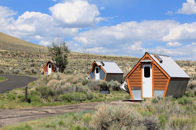 Wooden pentagon shaped structures located in a campground