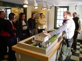 An interpretive park ranger demonstrates a working lock model at Canal Visitor Center