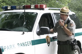 Protection ranger talks on the radio to park dispatch.